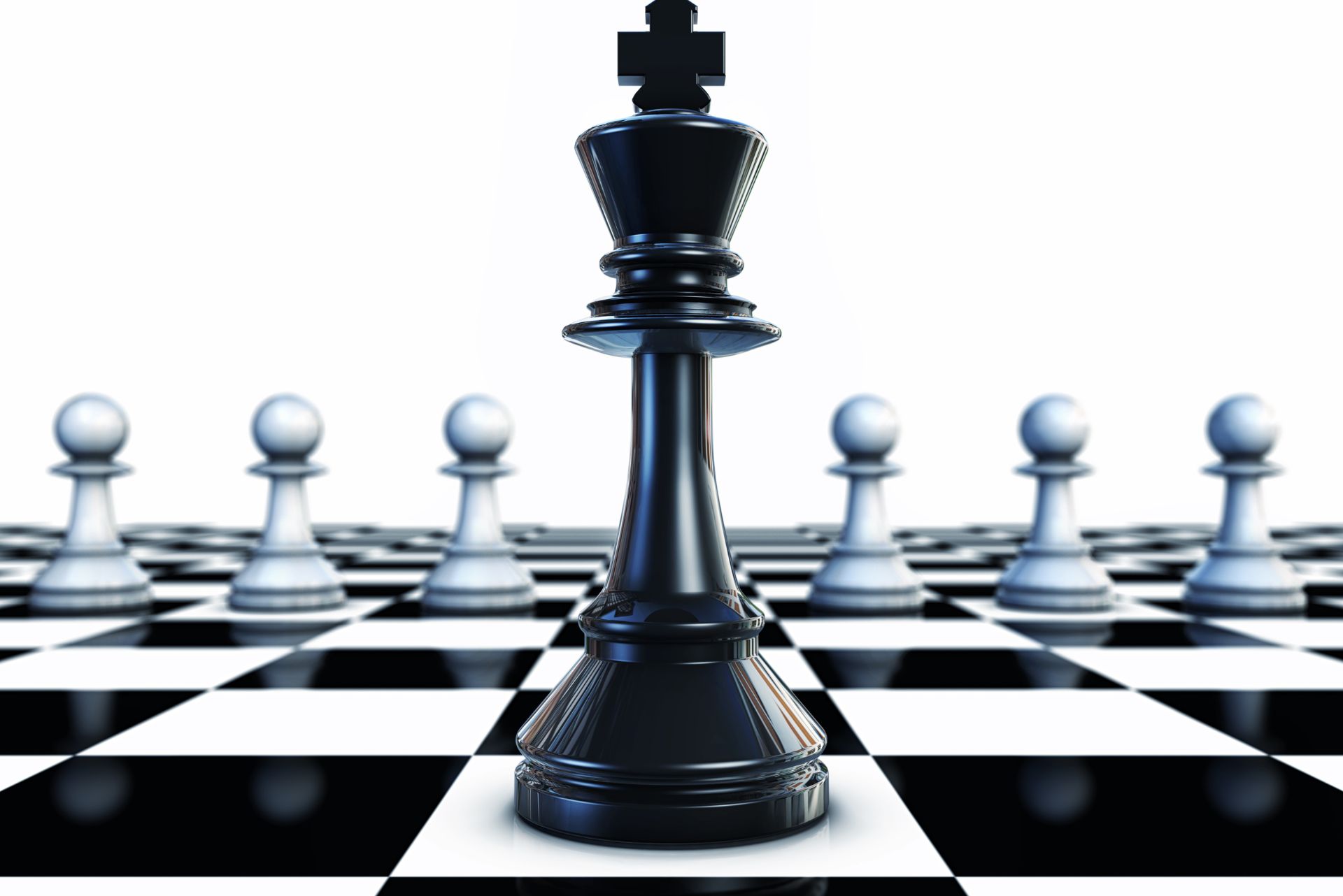 Motivated little boy sitting in the classroom and planning a move while playing chess on the